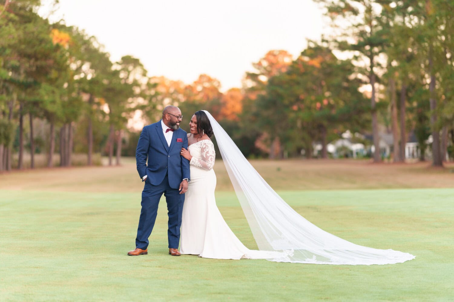 Bride holding on to the grooms arm looking into his eyes - Wedgefield Country Club