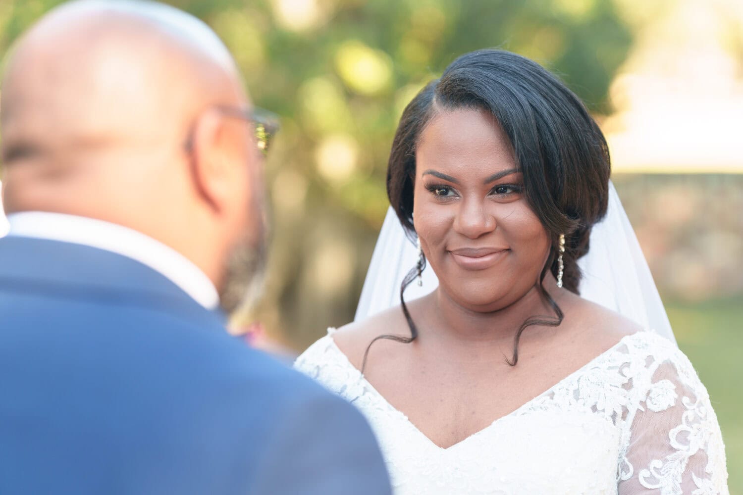 Bride looking into the groom's eyes during the vows - Wedgefield Country Club