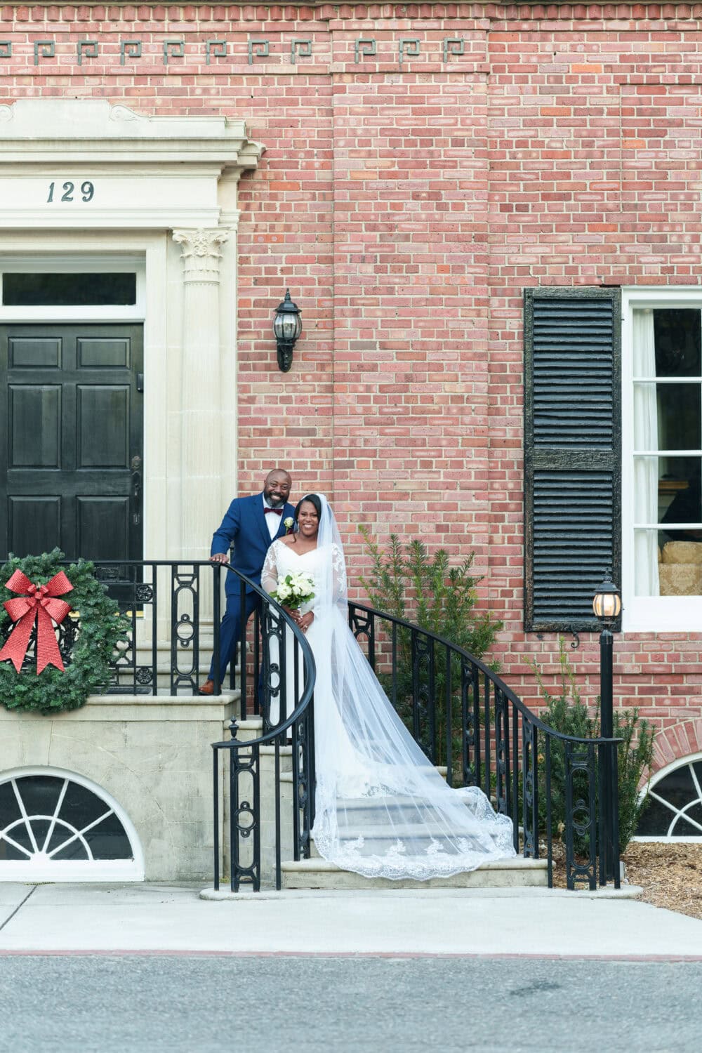 Portraits in front of the clubhouse steps with the bride and groom - Wedgefield Country Club