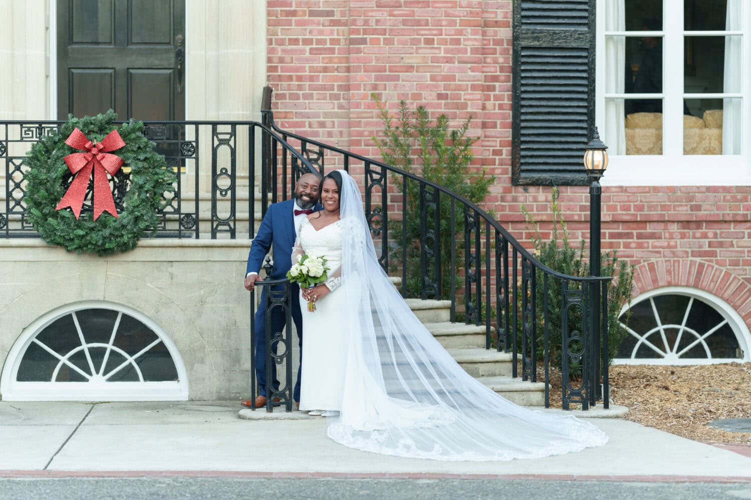 Portraits in front of the clubhouse steps with the bride and groom - Wedgefield Country Club