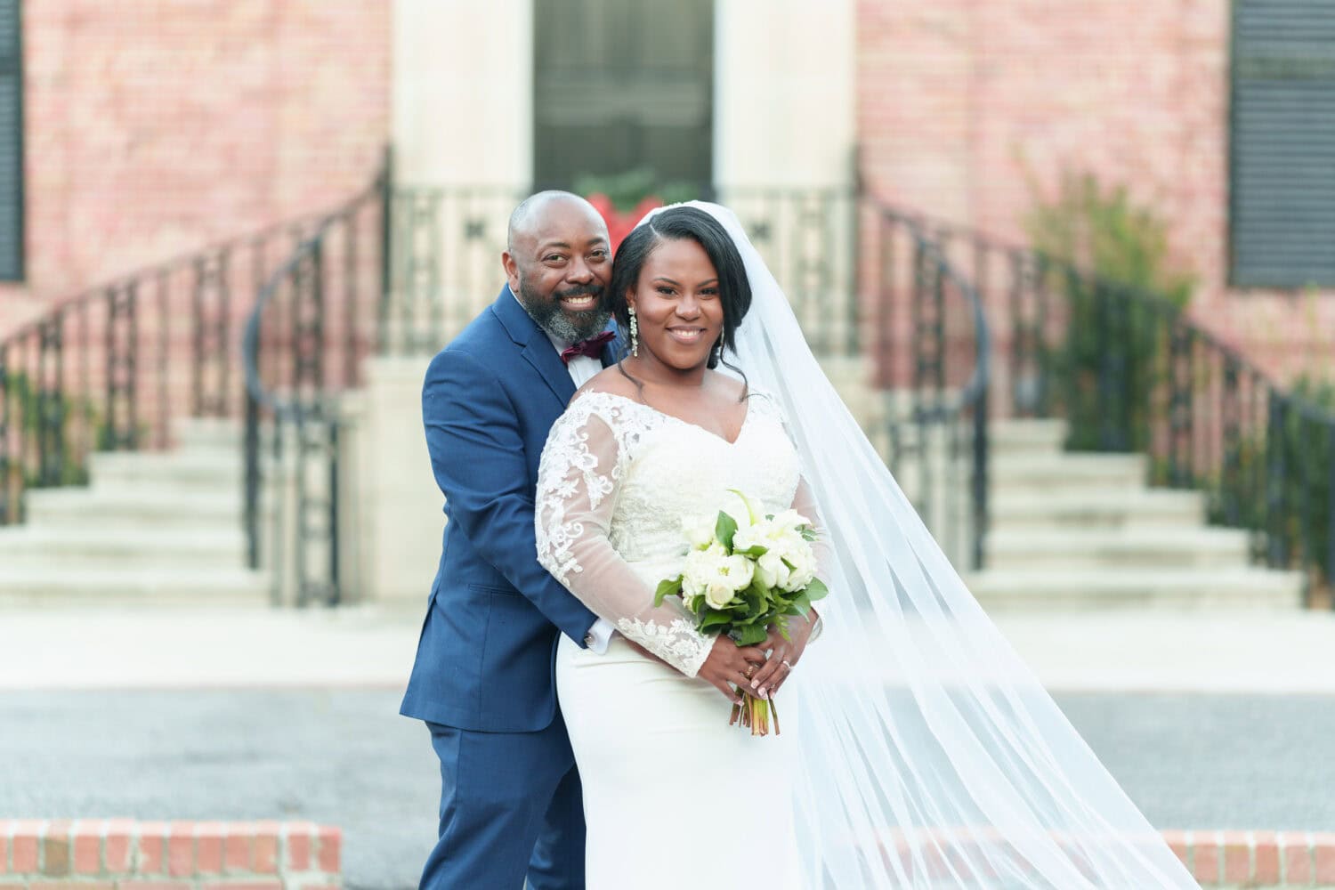 Portraits in front of the clubhouse steps with the bride and groom - Wedgefield Country Club