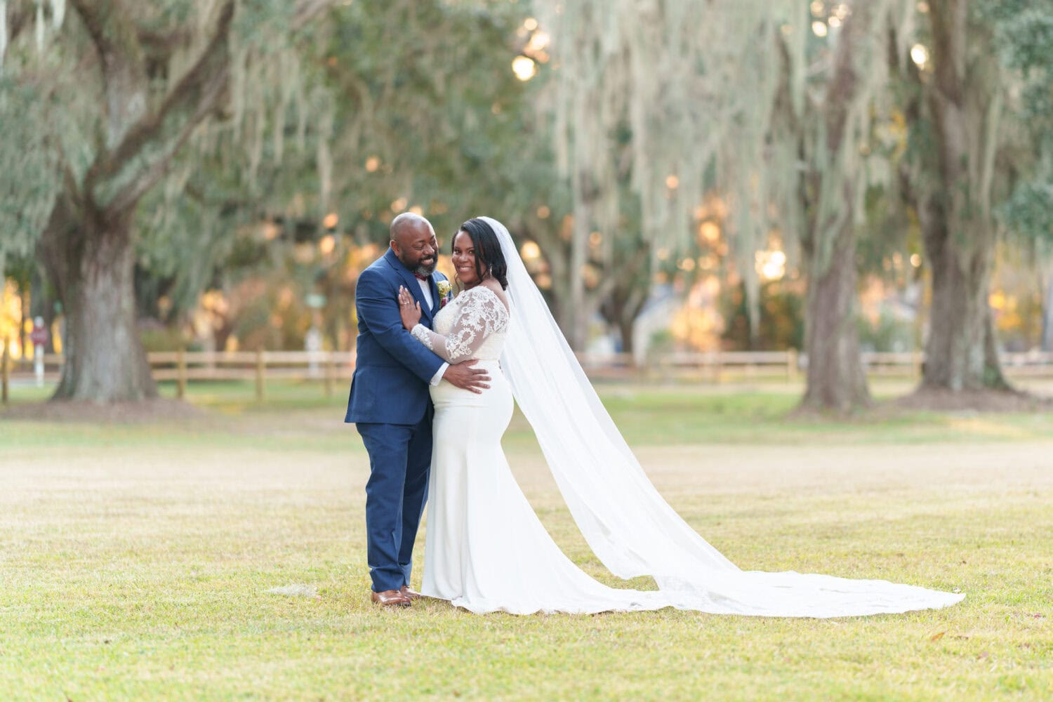 Portraits of the bride and groom under the mossy oaks in front of the clubhouse - Wedgefield Country Club