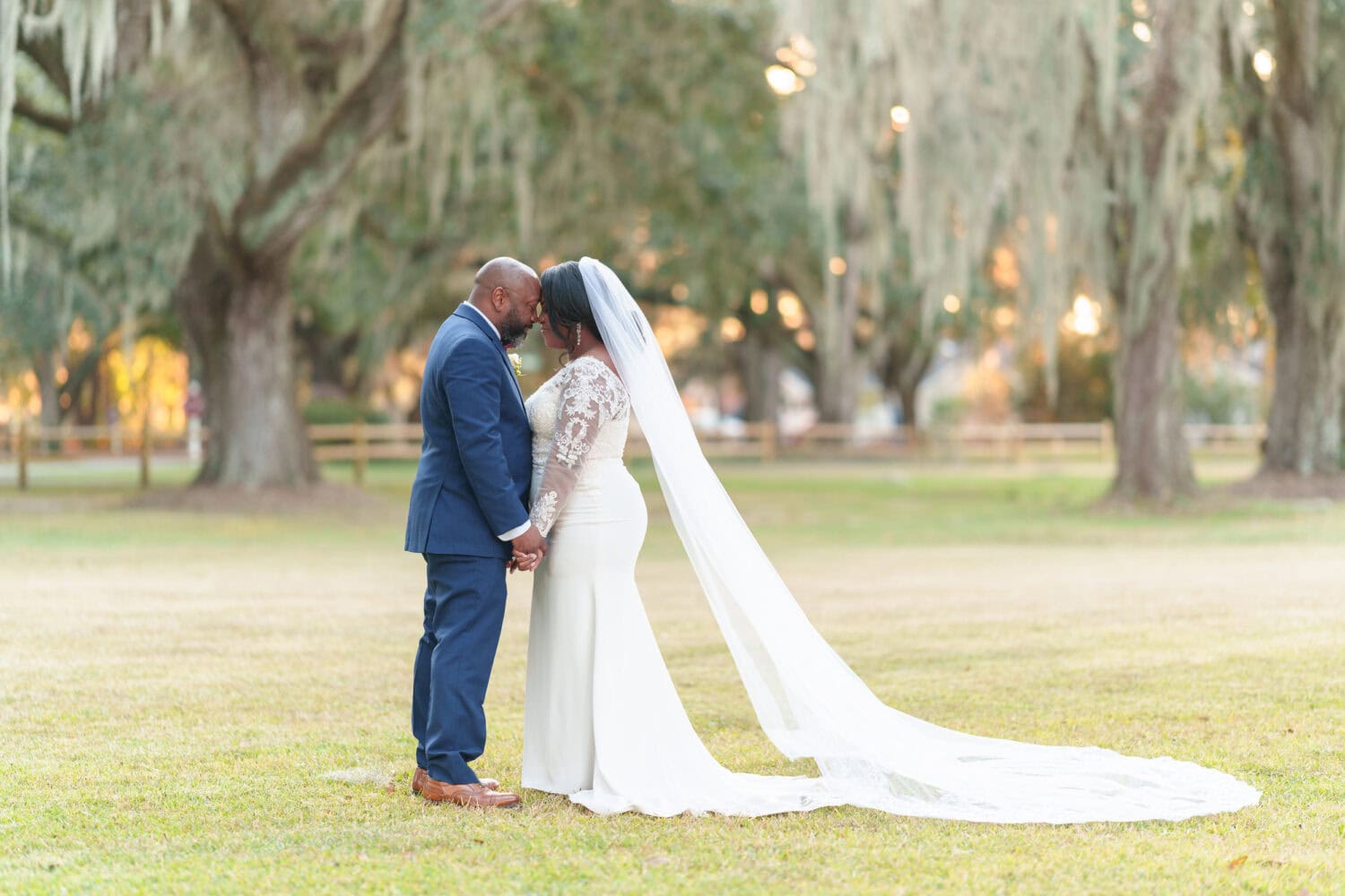 Portraits of the bride and groom under the mossy oaks in front of the clubhouse - Wedgefield Country Club