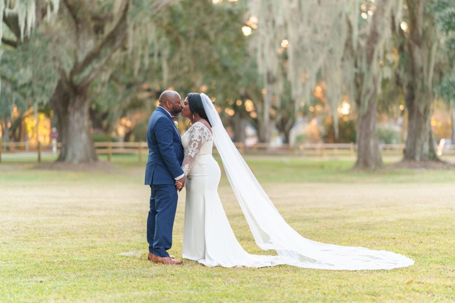 Portraits of the bride and groom under the mossy oaks in front of the clubhouse - Wedgefield Country Club