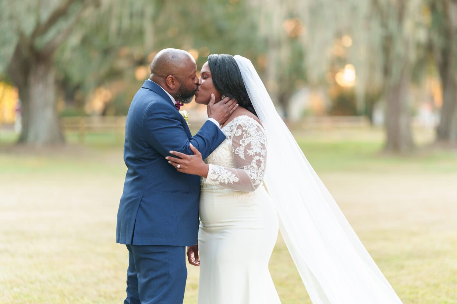 Portraits of the bride and groom under the mossy oaks in front of the clubhouse - Wedgefield Country Club