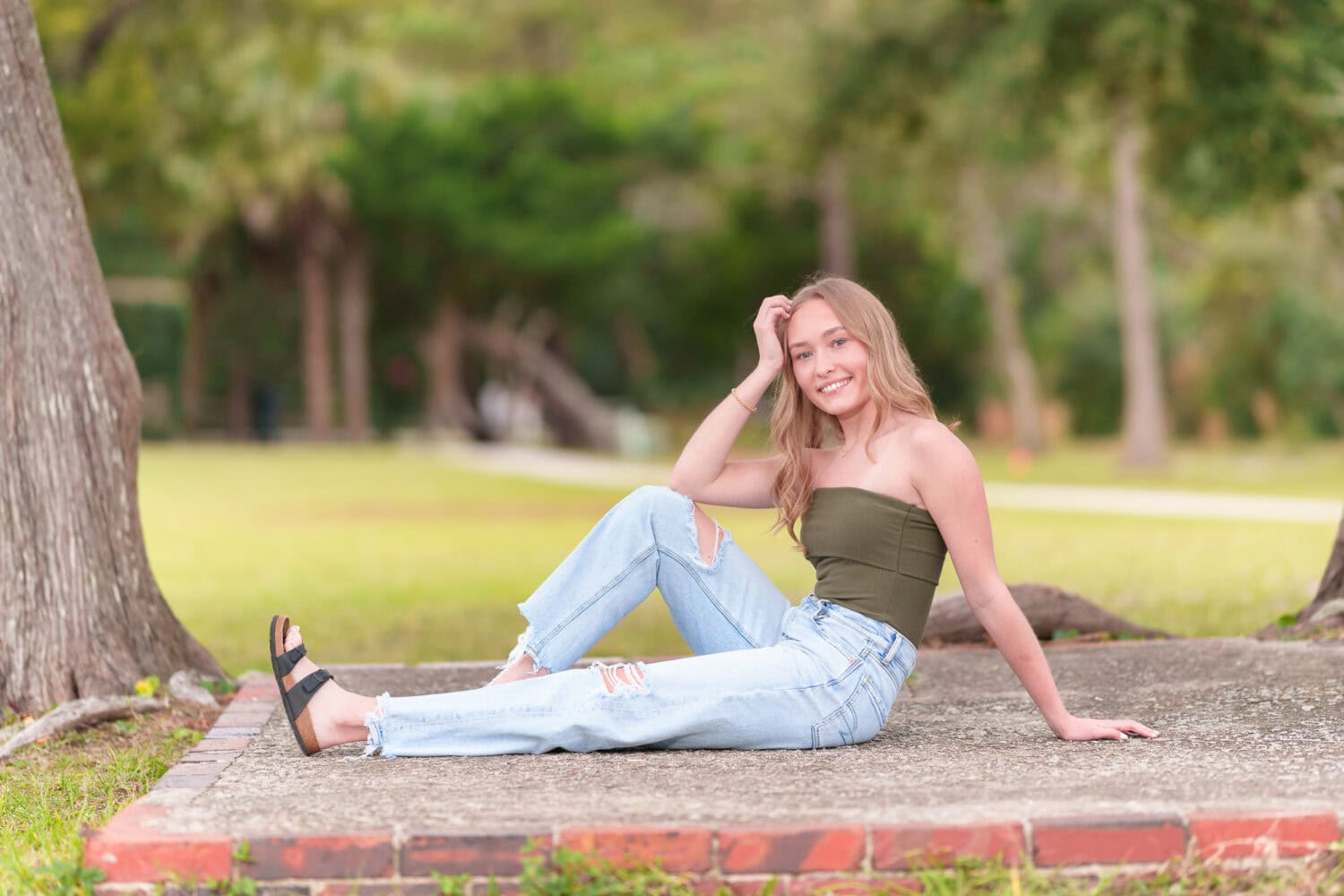 Senior girl in jeans laying by the trees - Huntington Beach State Park - Pawleys Island