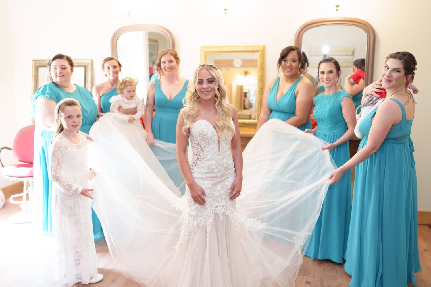 Bridesmaids fluffing out the bride's dress - Wildhorse at Parker Farms