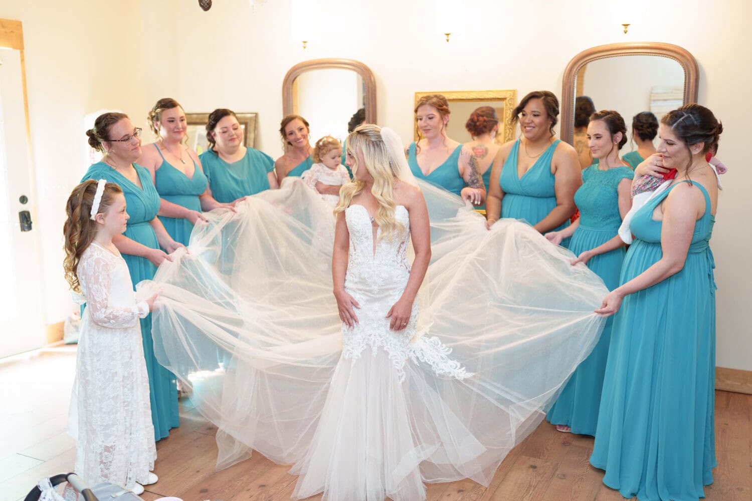 Bridesmaids fluffing out the bride's dress - Wildhorse at Parker Farms