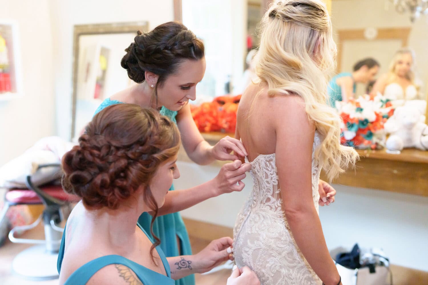 Bridesmaids helping with the dress - Wildhorse at Parker Farms