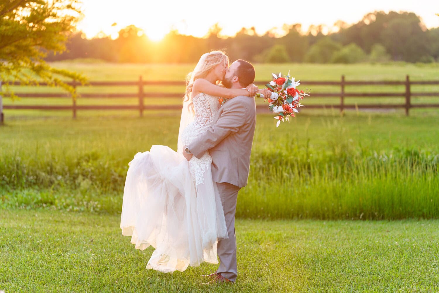 Groom lifting bride into the air - Wildhorse at Parker Farms