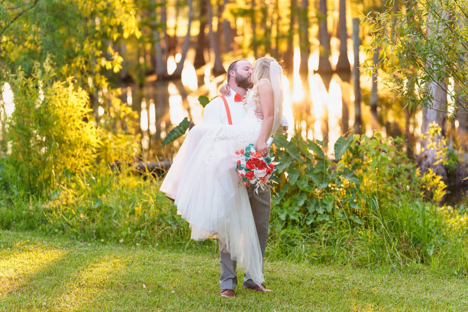 Groom lifting up the bride in the sunset - Wildhorse at Parker Farms