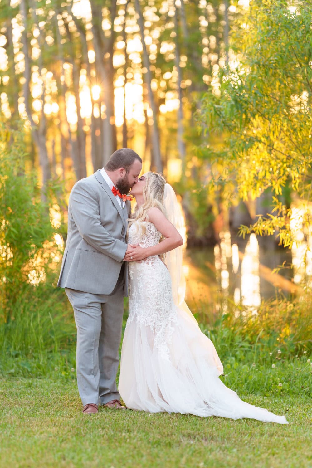 Kiss with sunlight filtering through the trees - Wildhorse at Parker Farms