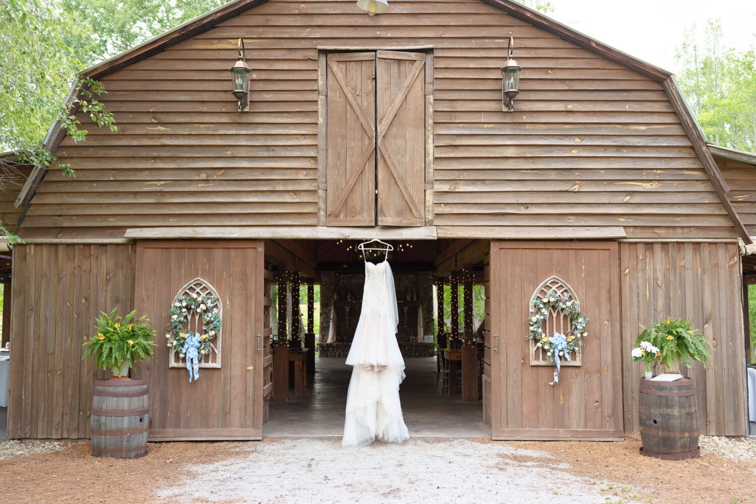 Wedding dress hanging in the barn doors - Wildhorse at Parker Farms